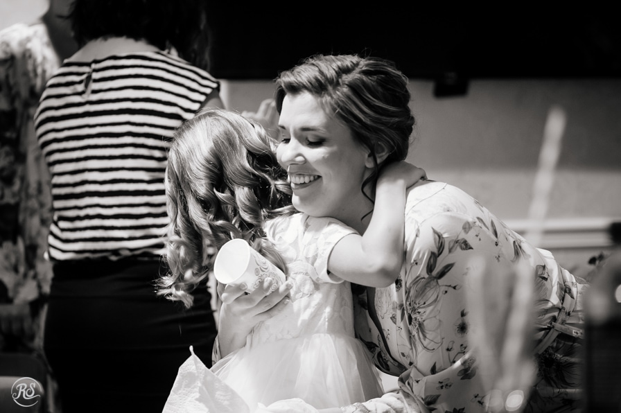 bride hugging flower girl