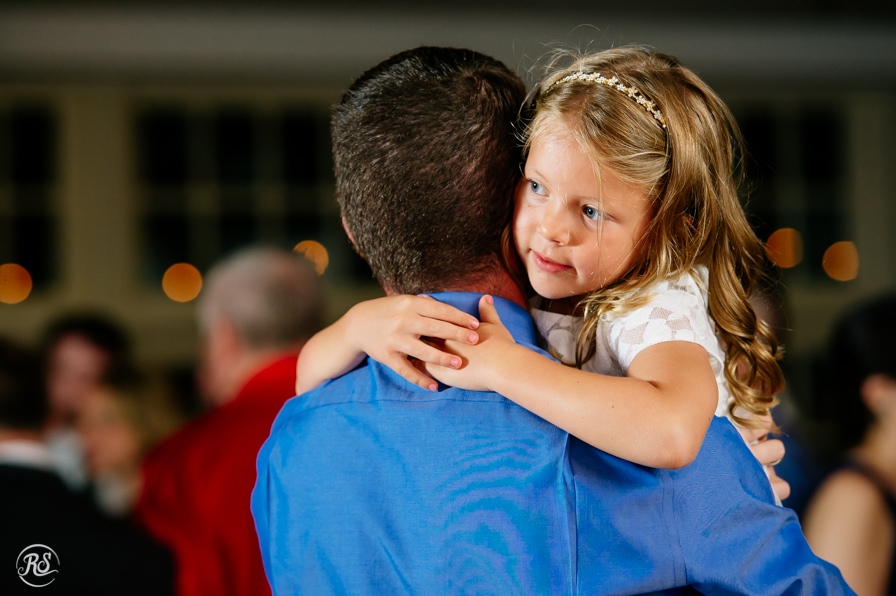 Flower girl dancing with father 