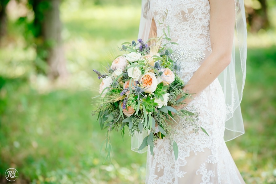 Lacy wedding dress and loose wedding bouquet 
