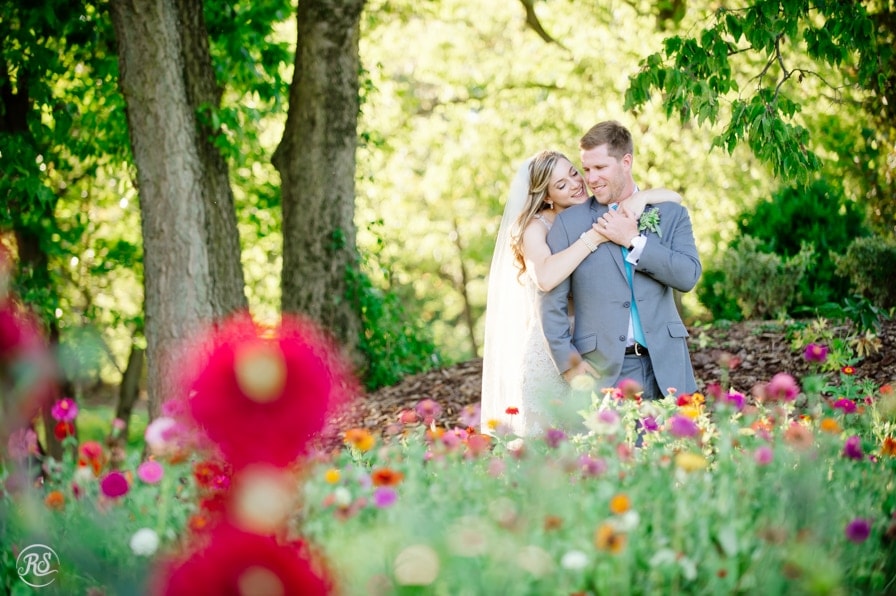Bride and groom in flower bed