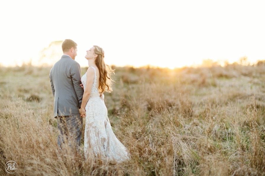 Bride and Groom in field at sunset