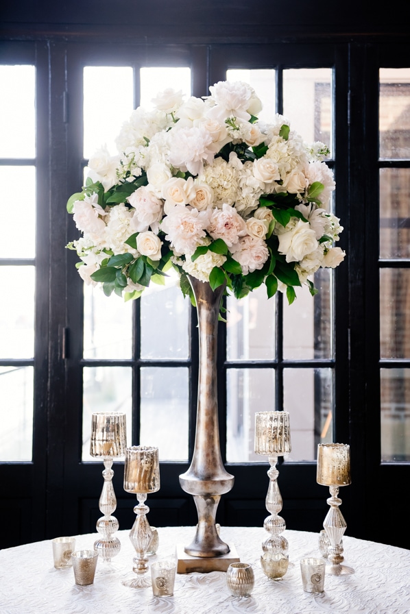 Escort Card table with lavish florals and vintage candle holders