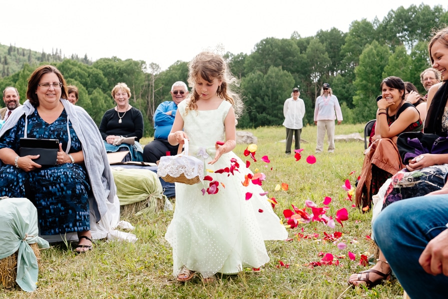 Outdoor wedding ceremony flower girl