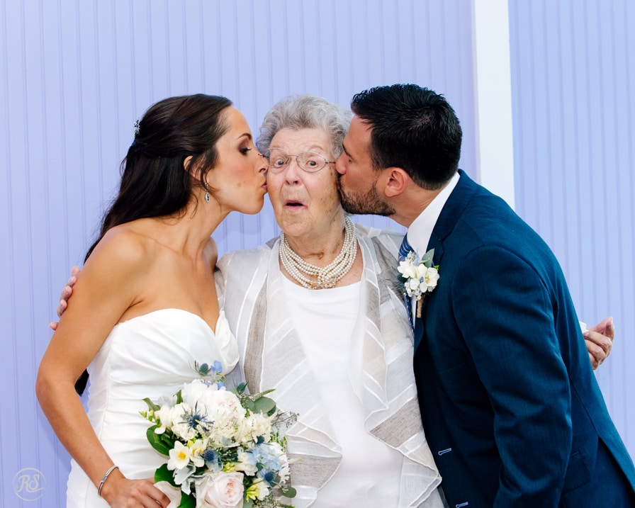 Bride and Groom Kissing Grandma