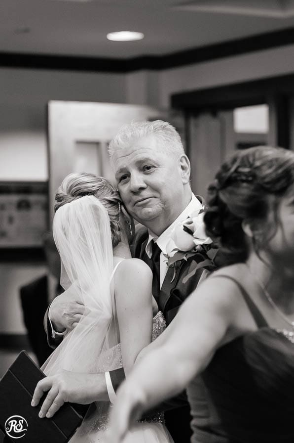 Father of the bride hugging his baby girl