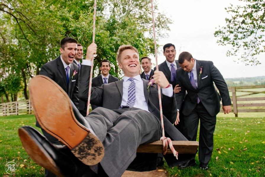 Groom on swing, having fun with groomsmen 