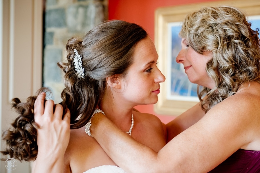 mother helping with wedding necklace 