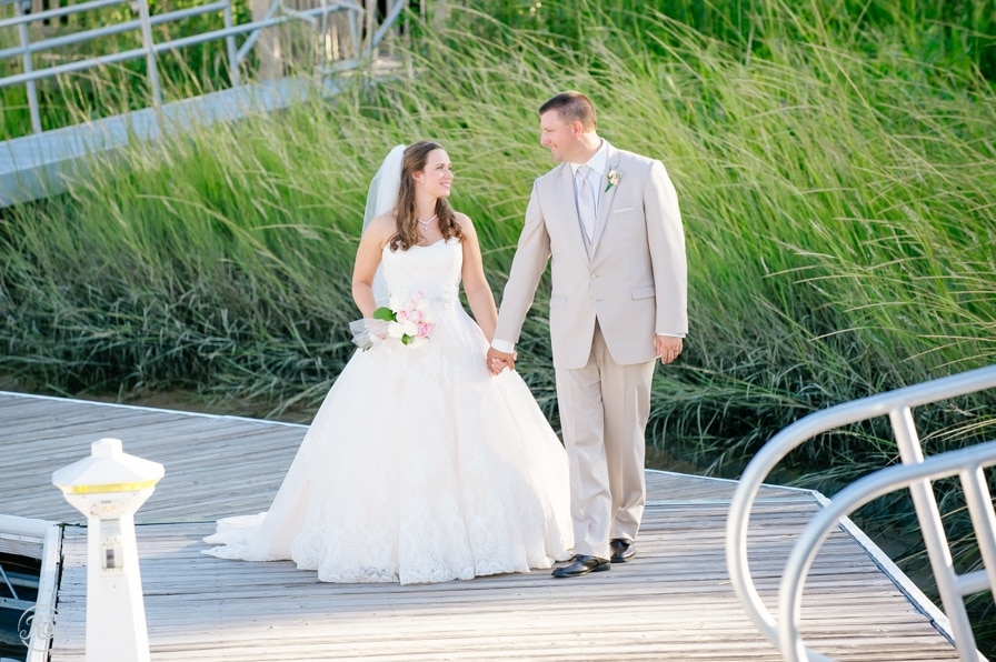 Bride and groom walking on docks 