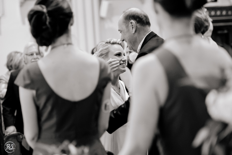 Bride embracing father at ceremony 