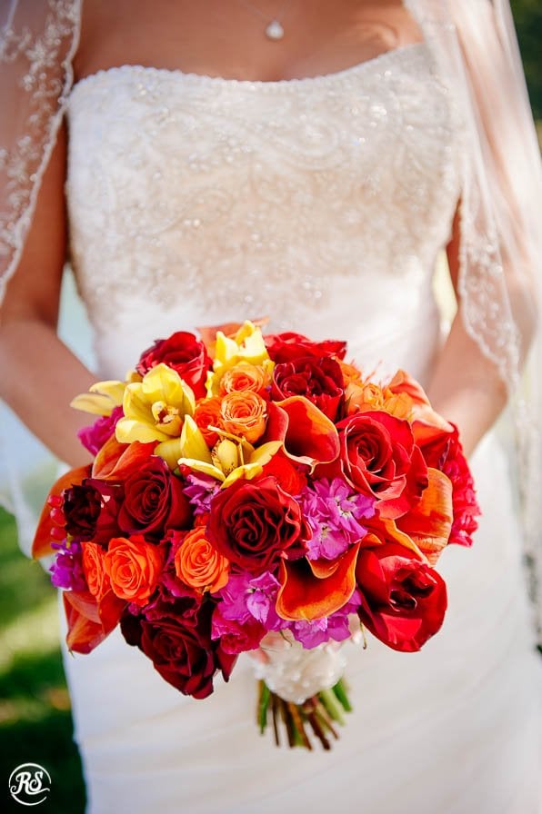 wedding bouquet with red, orange, yellow and pink flowers 