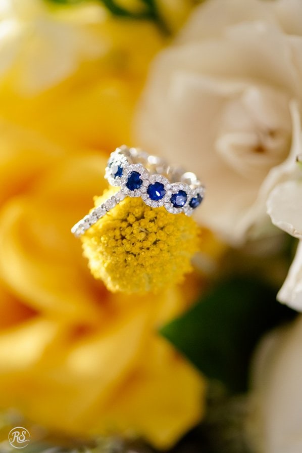 Yellow wedding flowers with blue sapphire engagement ring