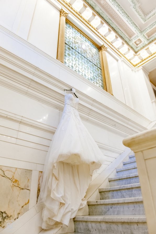 Baltimore Hotel Monaco Wedding. Sophia Tolli Dress hanging in Staircase