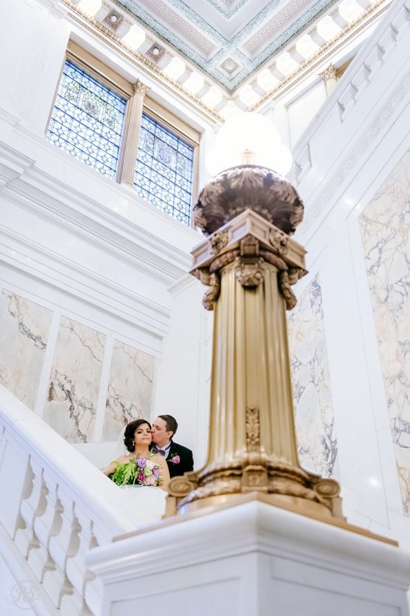 Bride and Groom snuggle on staircase