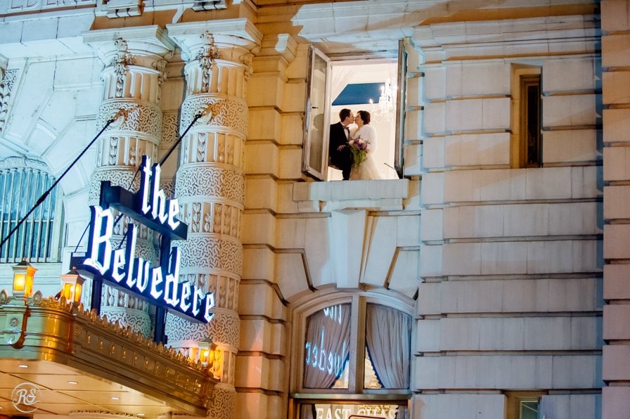 Bride and Groom in Window at night above the Belvedere Sign