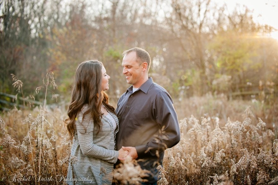 Engagement session in field at sunset