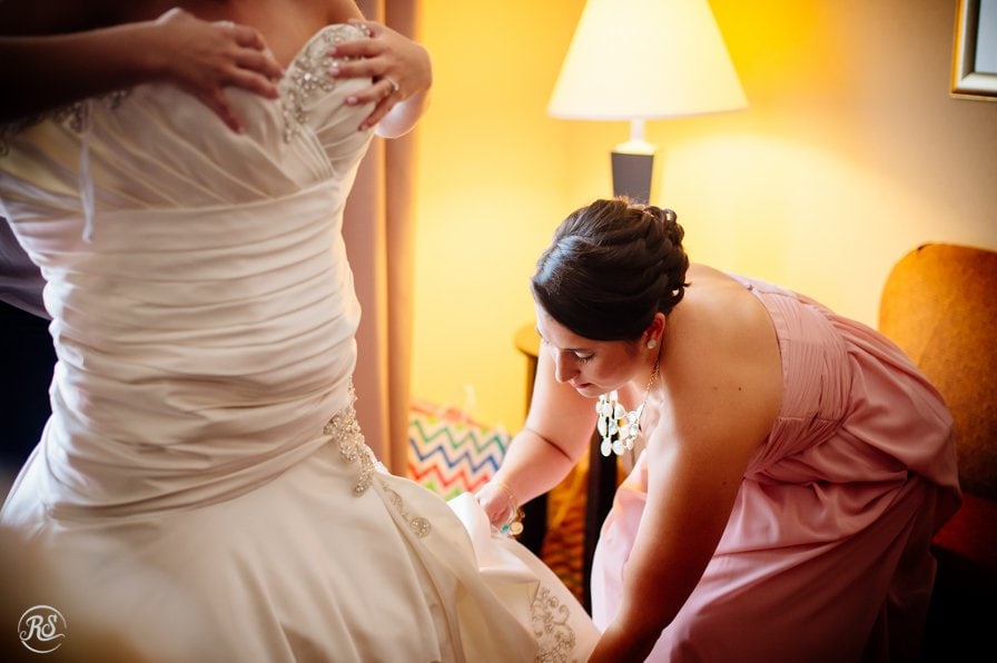 Bride getting into dress