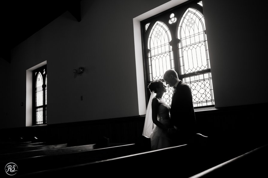 Bride and groom silhouette in stain glass window 