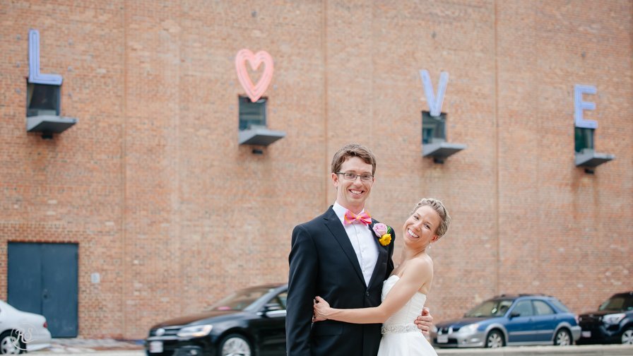 Bride and Groom with Love sign