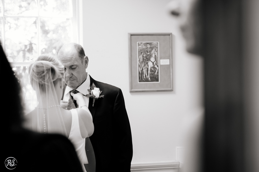 Bride adjusting dad's tie