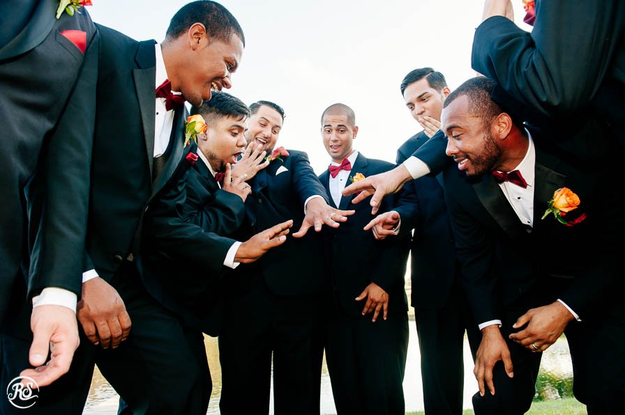 Groomsmen admiring grooms ring
