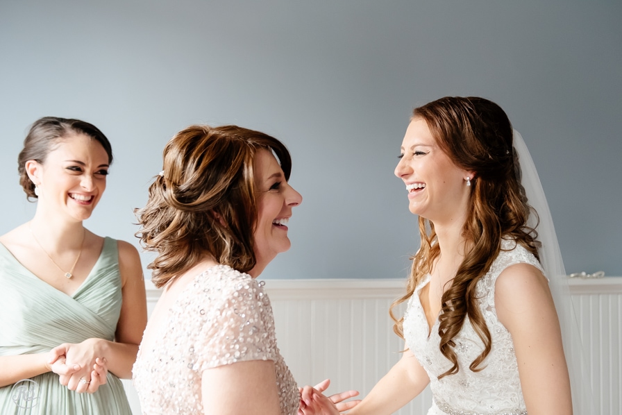 bride laughing with mom and sister 