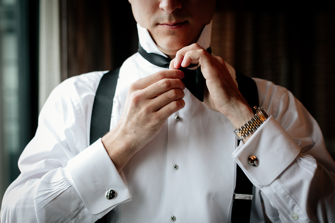 groom fixing bowtie