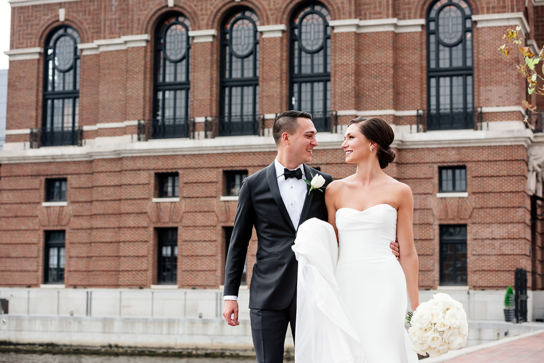 groom and bride walking in fells point baltimore
