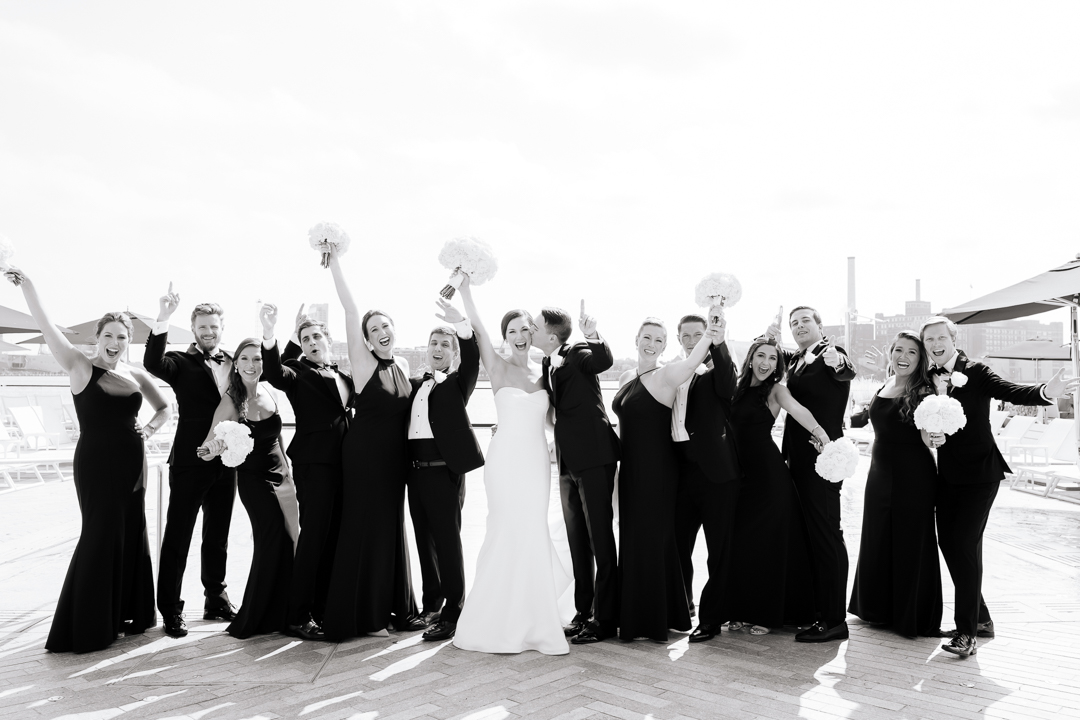 wedding party cheering with the bride and groom