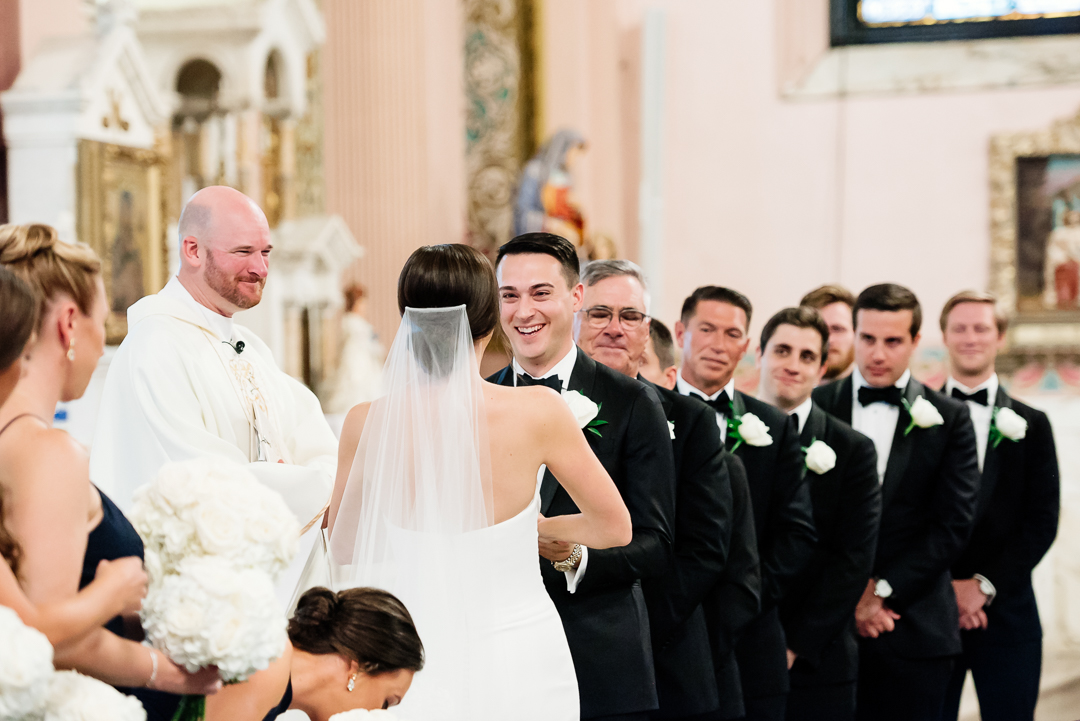 groom smiling at the bride during wedding ceremony
