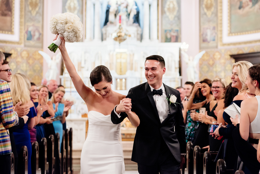 newlyweds just married walking down church aisle
