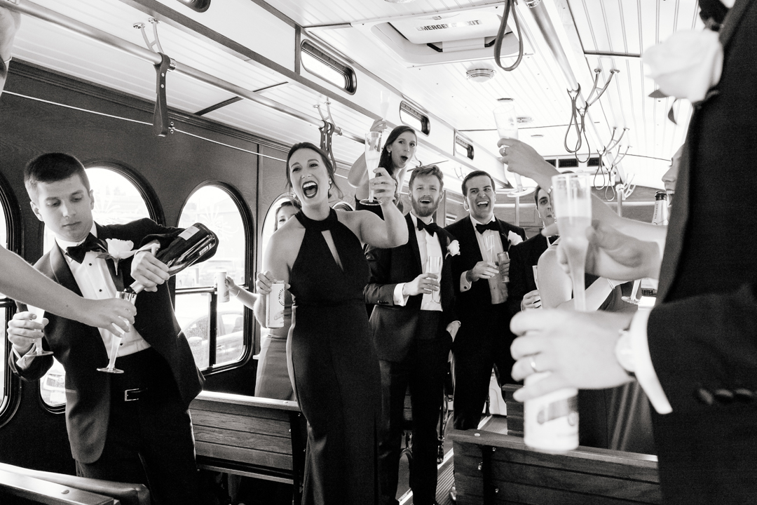 wedding party celebrating after the ceremony while on party trolley