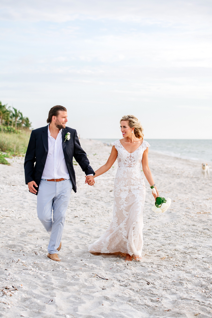 Captiva-island-beach-wedding-at-sunset bride and groom walking the beach at sunset on Captiva island on their wedding day