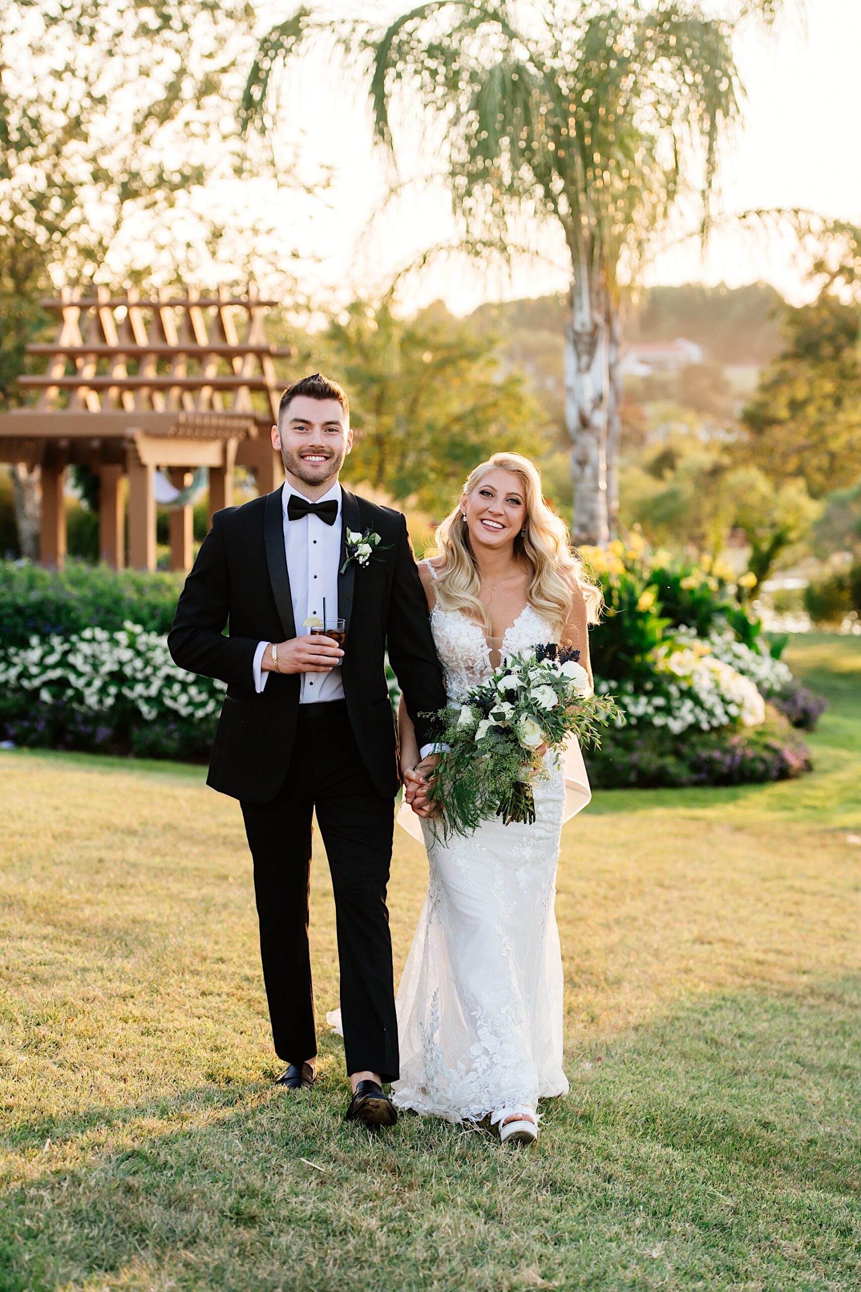 bride and groom walking the lawn ceremony site at herrington on the bay