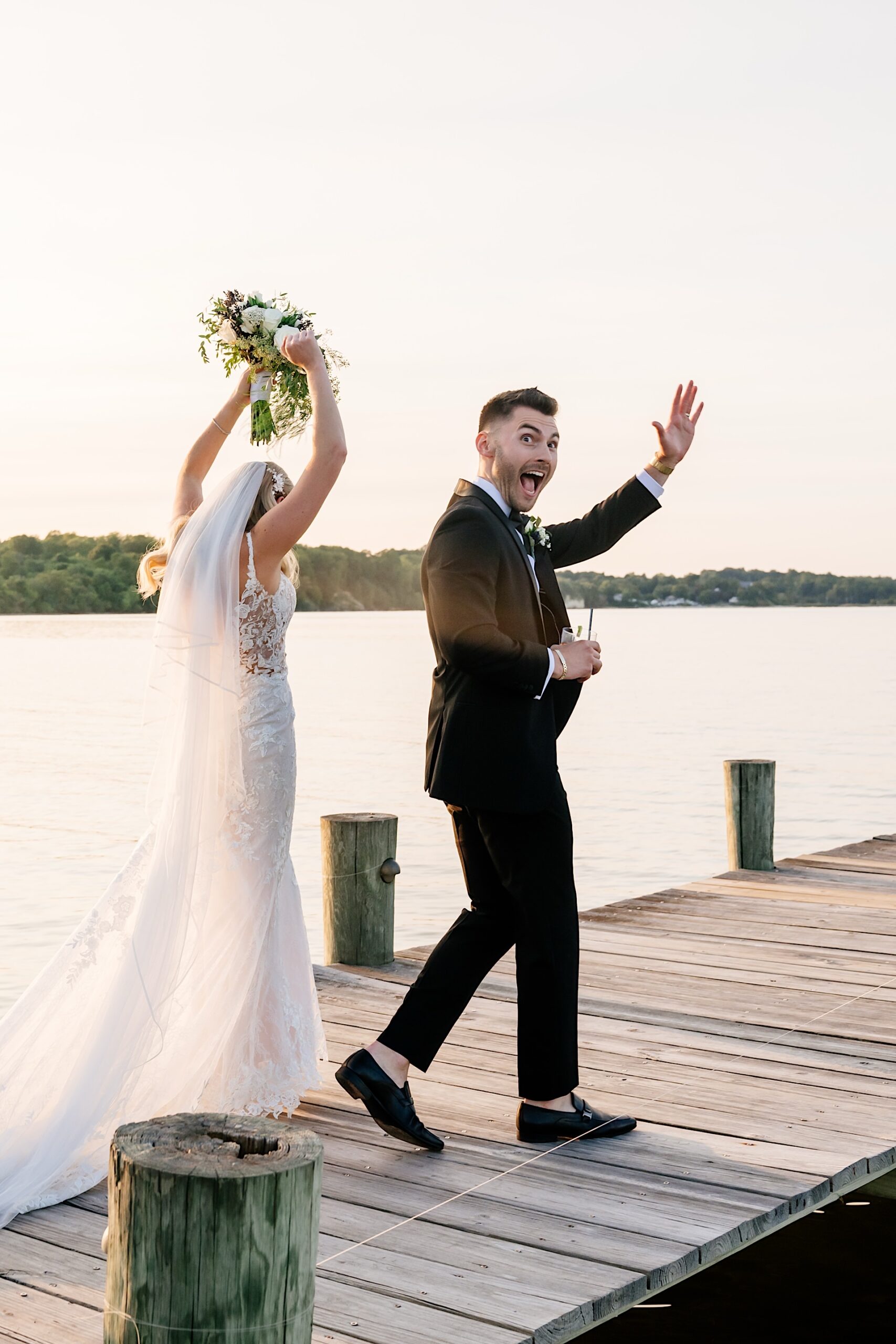 bride and groom celebrating and waving to guests after ceremony