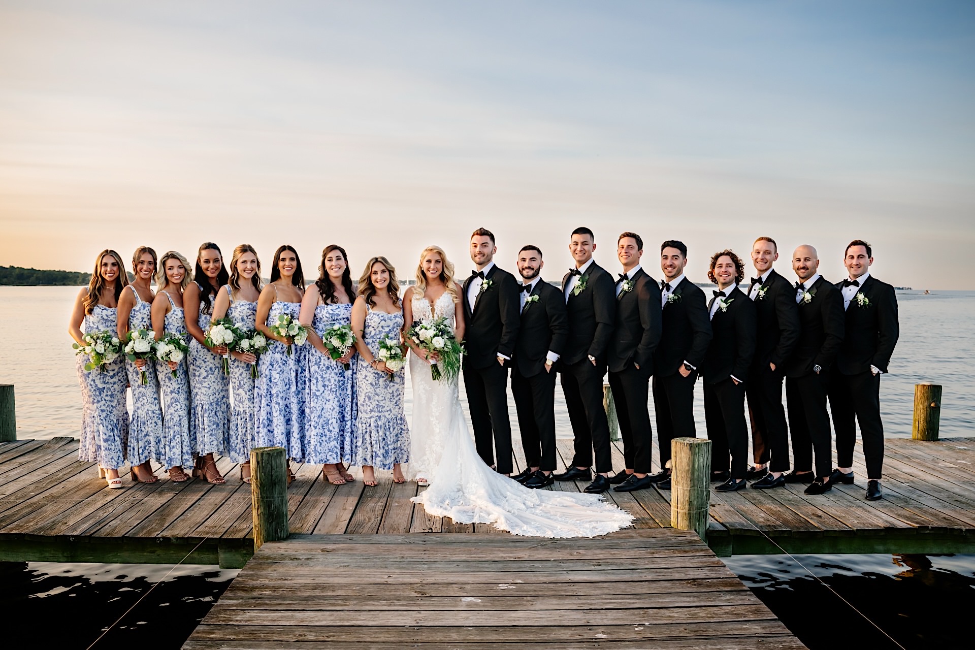 wedding party posing on pier at herrington on the bay wedding