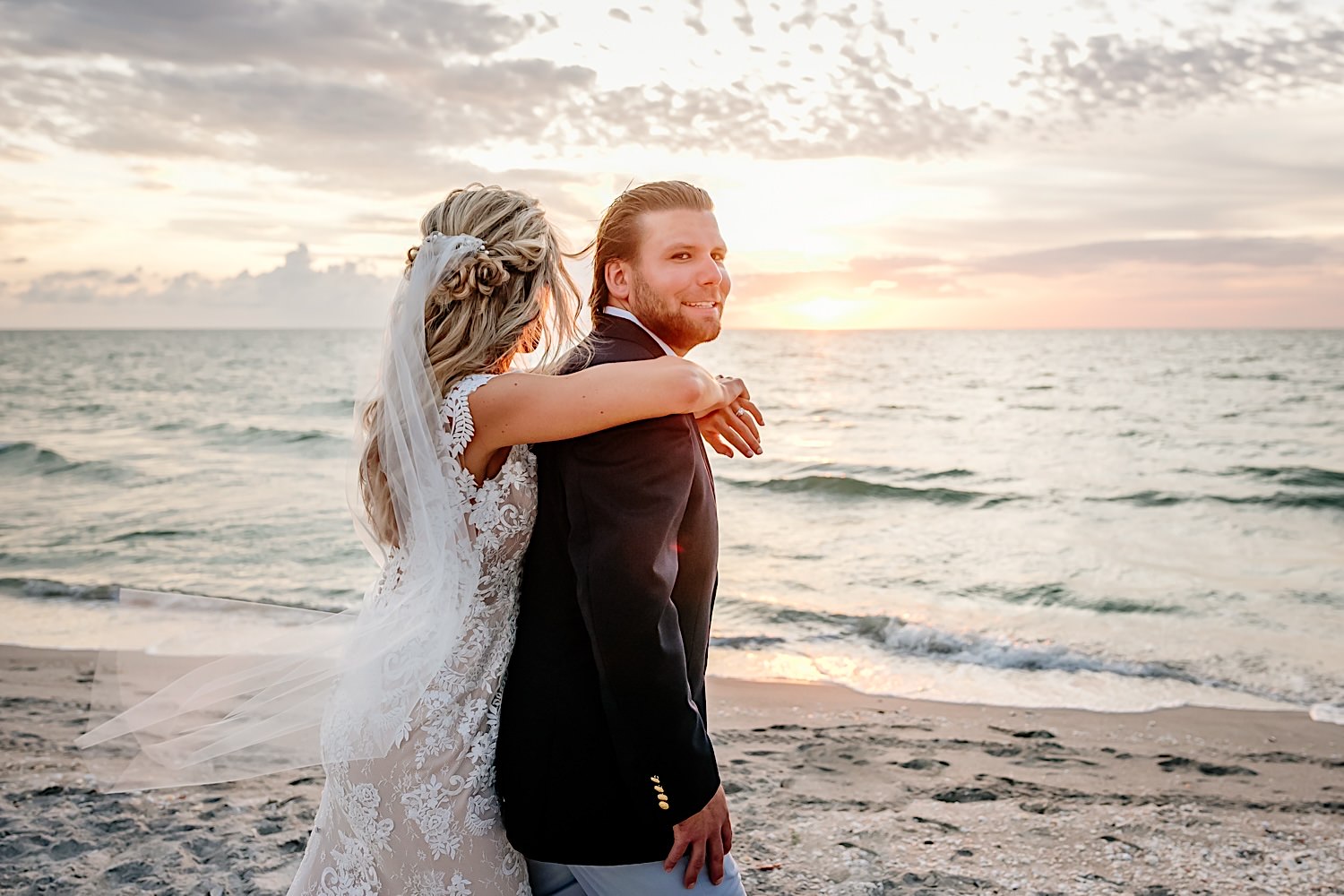 sunset photos on the beach of a wedding couple
