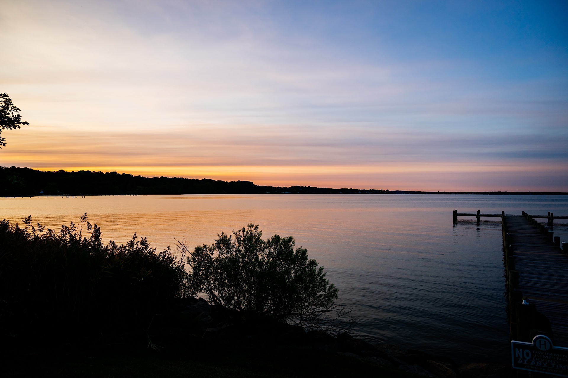 sunset over the water at herrington on the bay